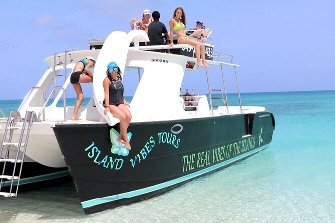 Full Day Beach BBQ Lunch & Snorkeling Excursion in Grace Bay - The boat setup: shade, loungers, and the water slide